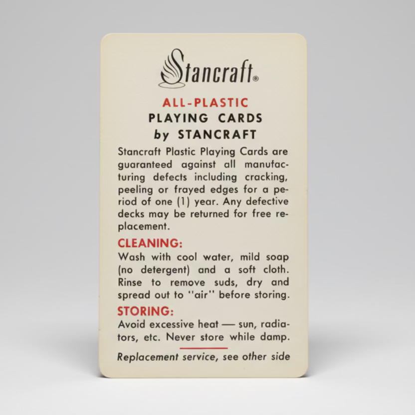 Stancraft all-plastic playing cards instruction card on a textured surface