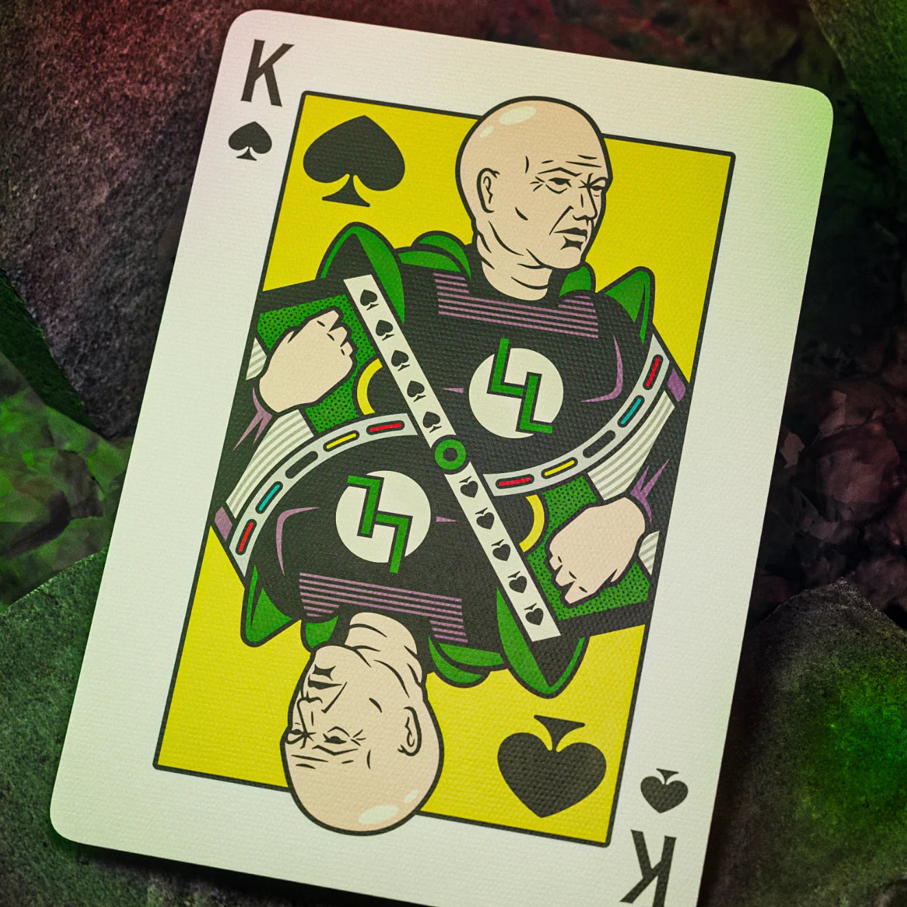 Playing card with a king of spades design featuring a character in green and purple attire.