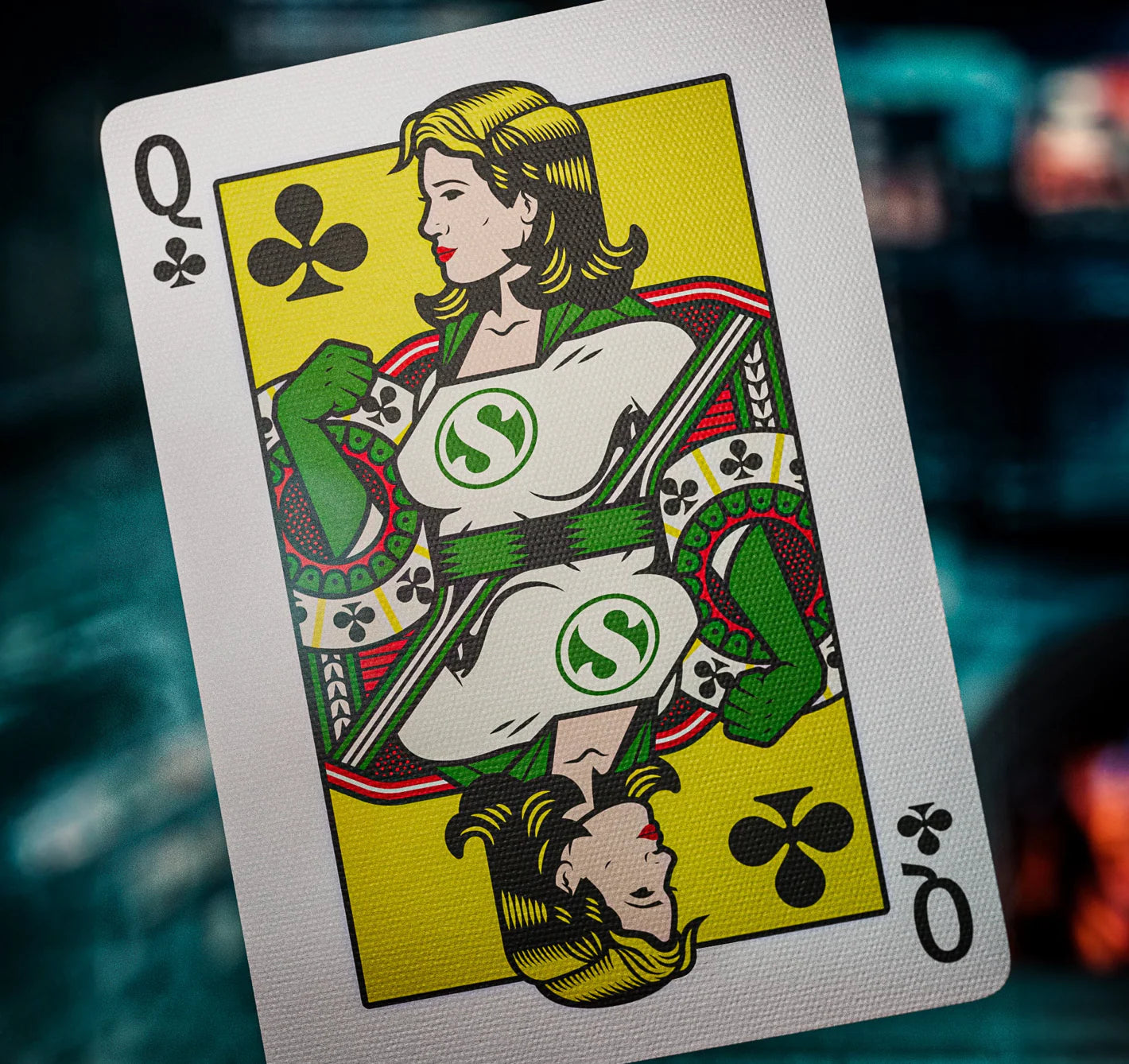 Playing card featuring a stylized female figure with a green symbol on a yellow background
