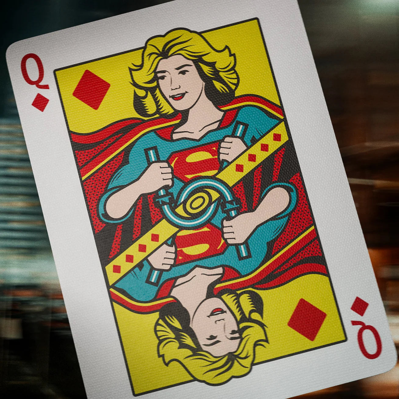 Playing card with a superhero design on a blurred background