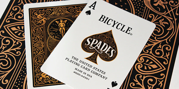 Bicycle playing cards with spades logo on a decorative background