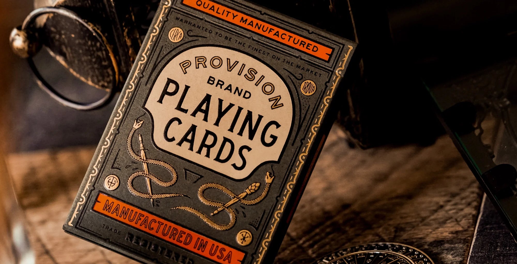 Provision Brand playing cards with leather casing on a rustic background