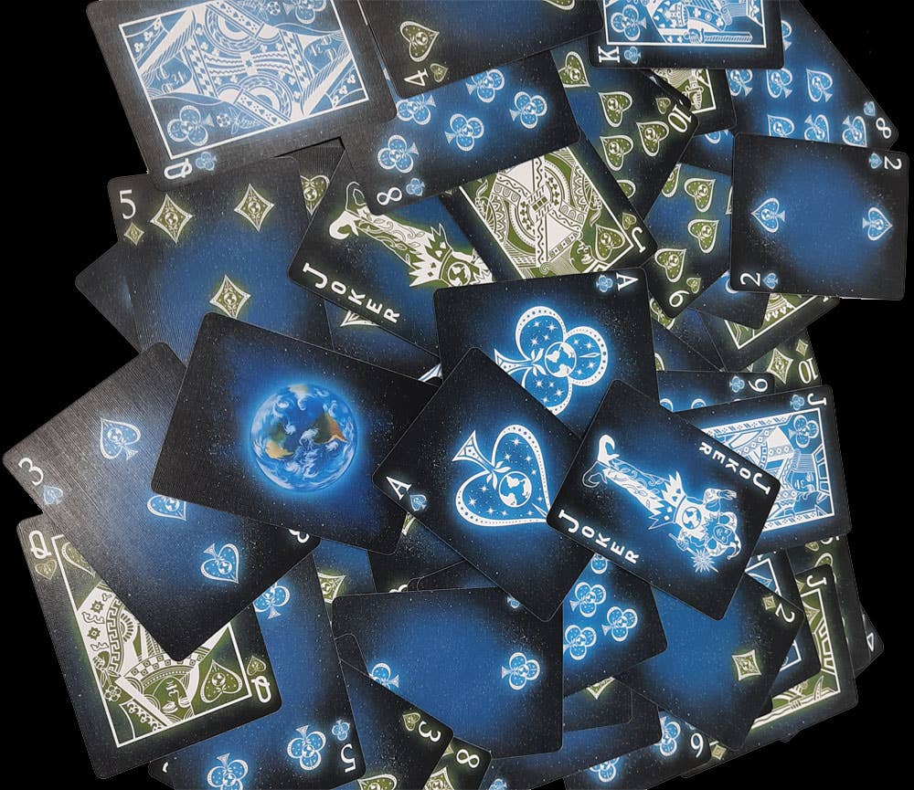 Playing cards with blue and white designs on a black background