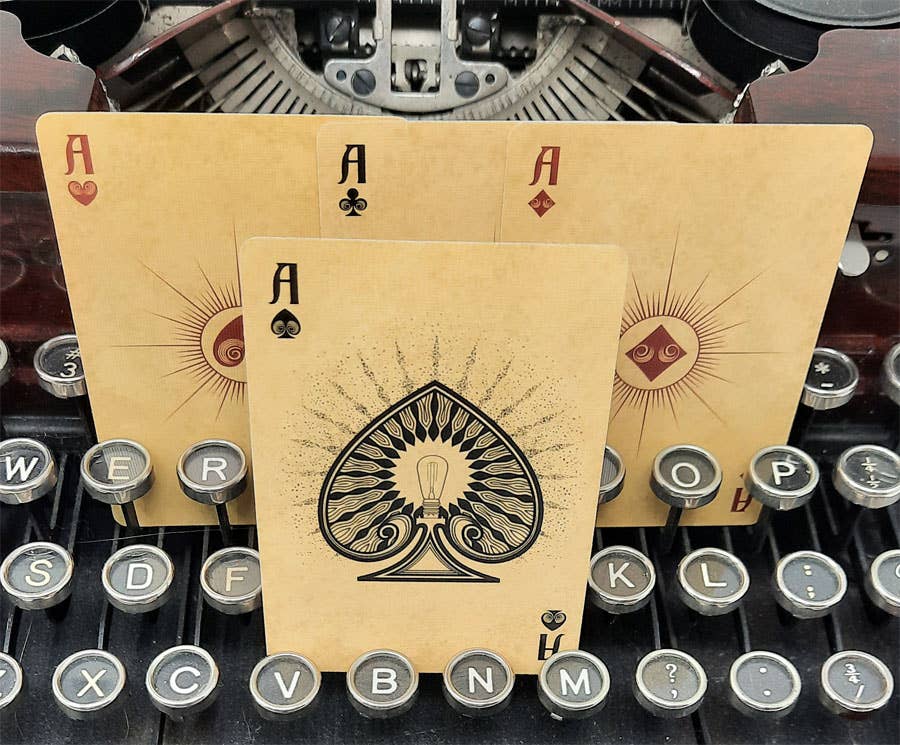 Playing cards with ace symbols on a typewriter