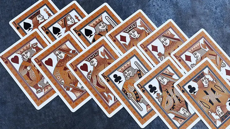 Set of playing cards with intricate designs on a textured surface