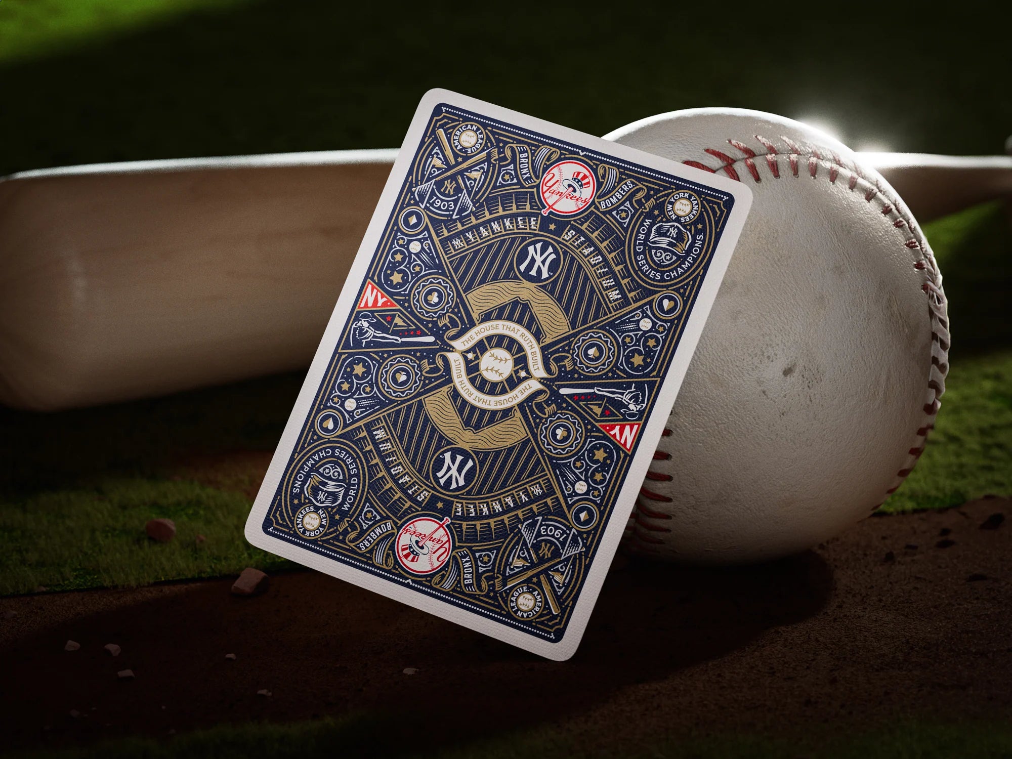 Back of the Yankees tuck box resting on the dirt near a bat and baseball, covered in navy and gold baseball-themed artwork.