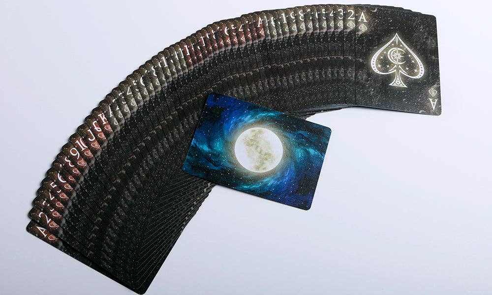 Fanned deck of cards with a galaxy-themed card on a white background