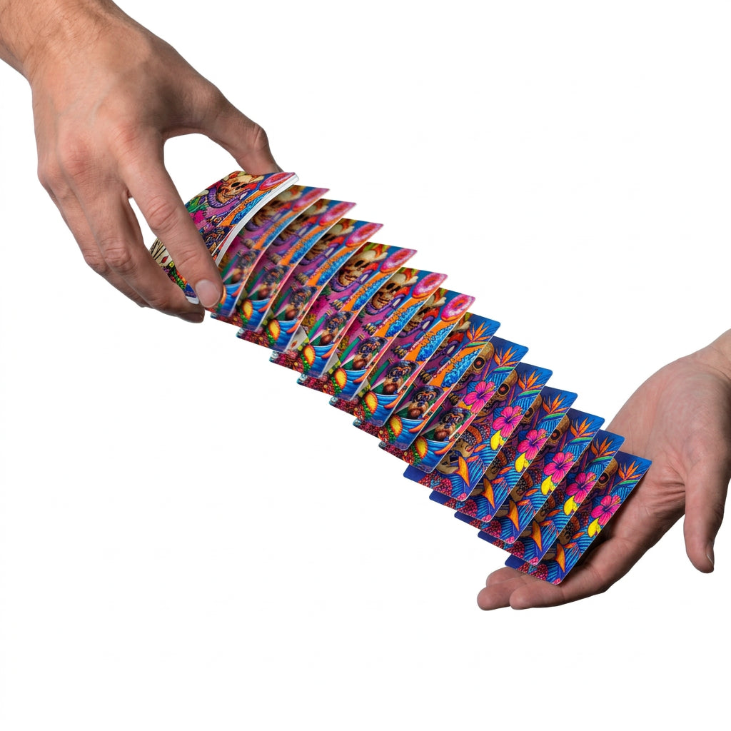 Bad to the Bone Boardwalk playing cards cascading between two hands with colorful illustrated backs visible