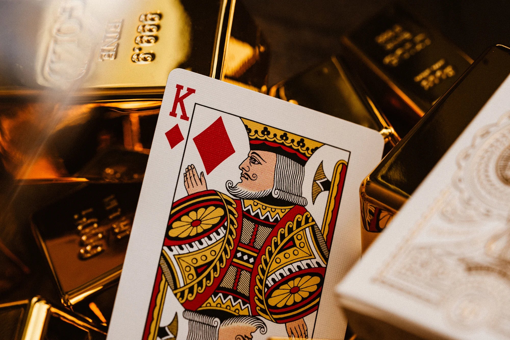 King of diamonds from Tycoon 25th Anniversary deck on a pile of gold bars.