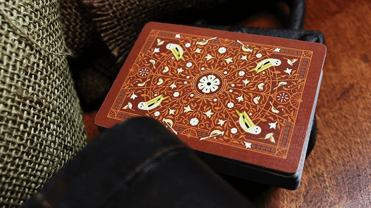 Bicycle Aviary Orange one-way card back with birds, flowers, stars, and intricate botanical scrollwork
