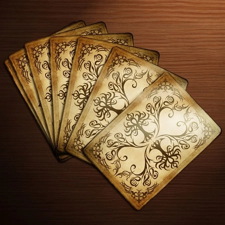Bicycle Gnomes Playing Cards fanned to show the aged parchment back with black floral and woodland ornament