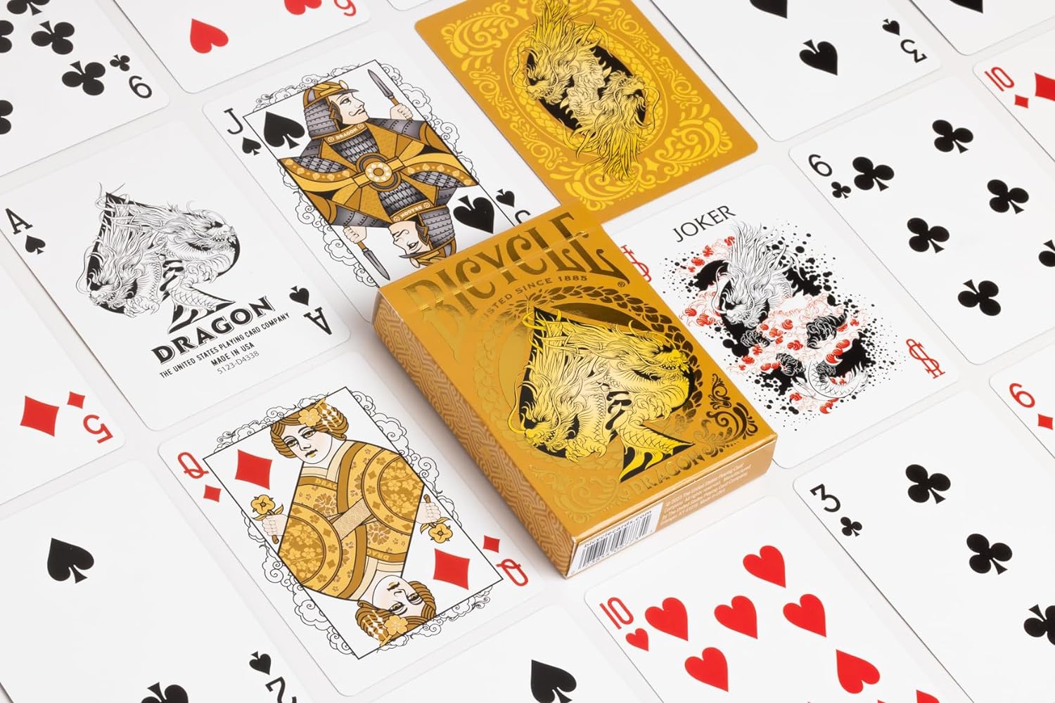 Bicycle Gold Dragon deck showing custom Ace of Spades, gold court cards, custom Joker, card back, and gold-foil tuck