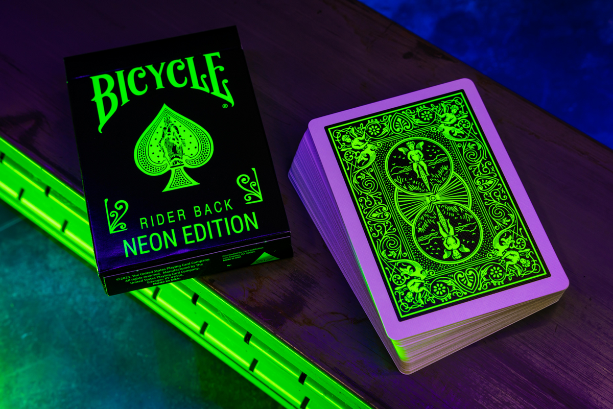 Bicycle Neon Green-Glo tuck box and Rider Back design under UV blacklight