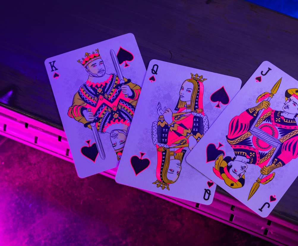 Bicycle Neon Star-Fire Pink custom spade court cards under UV blacklight