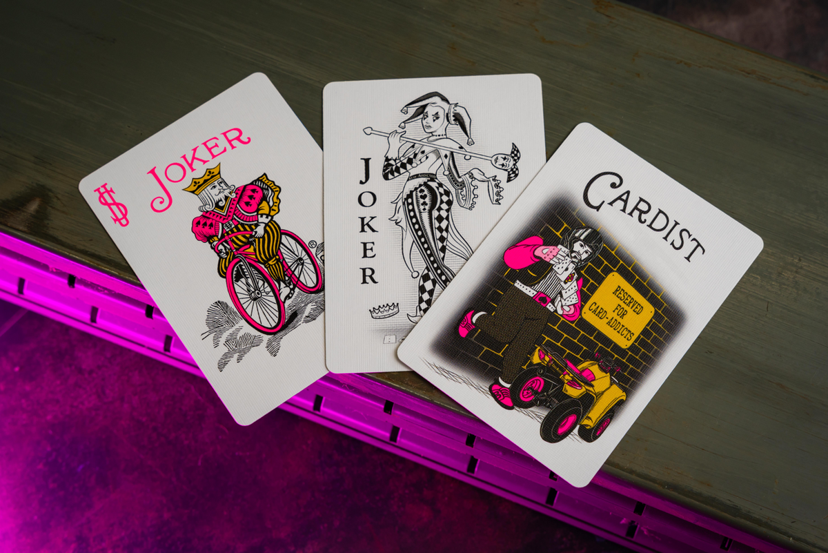 Bicycle Neon Star-Fire Pink custom Joker, Bicycle Joker, and cardistry card in ambient light