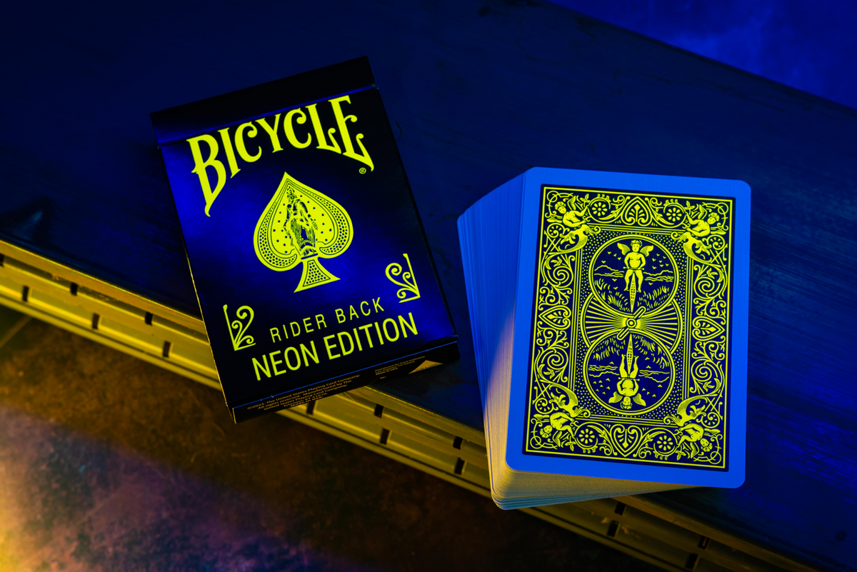 Bicycle Neon Yellow-Starburst tuck box and yellow Rider Back design under UV blacklight