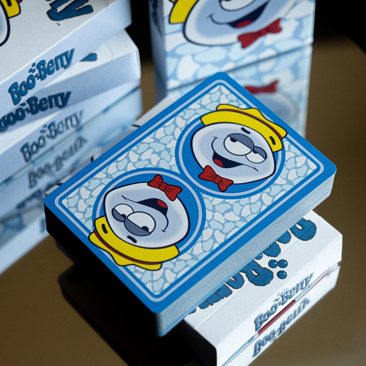 Angled overhead view of a Boo Berry deck displayed across stacked tuck boxes.