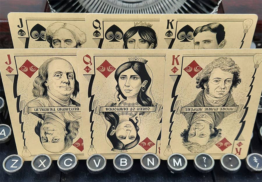Playing cards with historical figures on a dark background