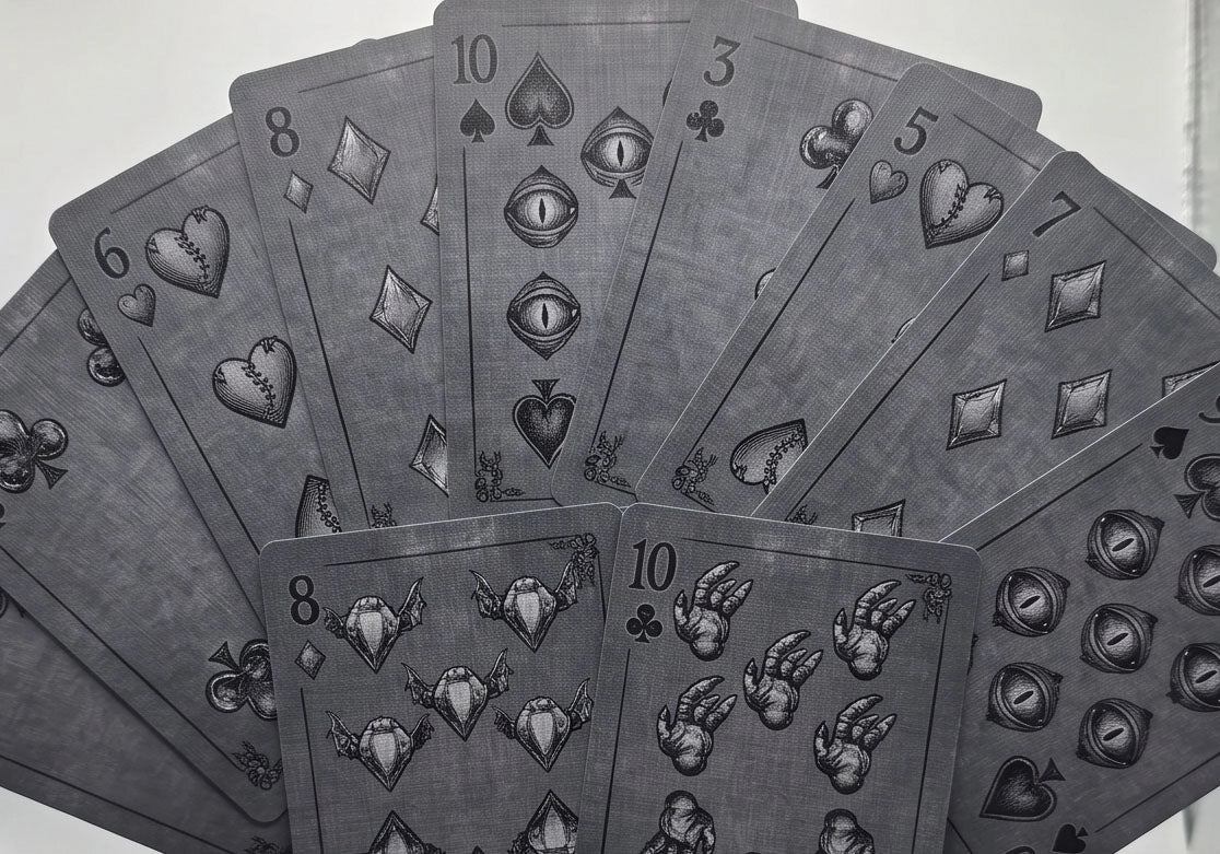 Classic Monsters Playing Cards number cards with stitched hearts, eye-shaped spades, winged diamonds, and claw-like club pips