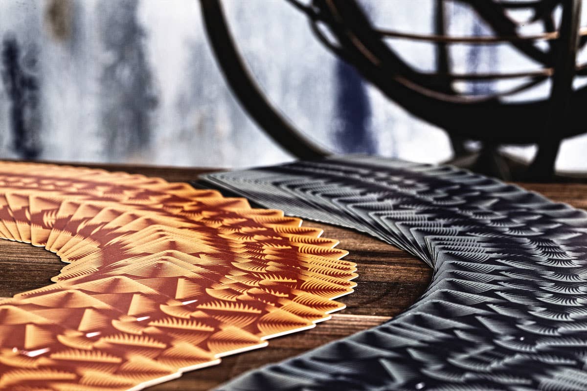 Borderless Polaris Equinox Light and Dark playing cards displayed in fans