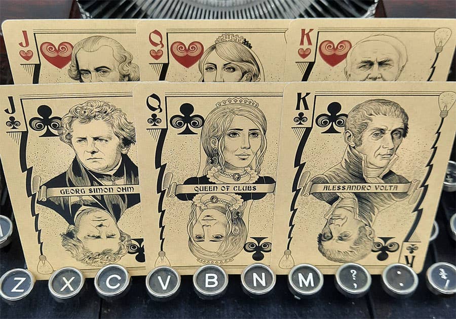 Playing cards with historical figures on a dark background