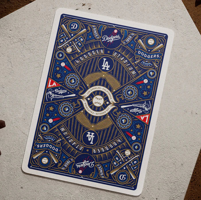 Dodgers card back laid flat on home plate, displaying detailed blue and gold symmetrical design.