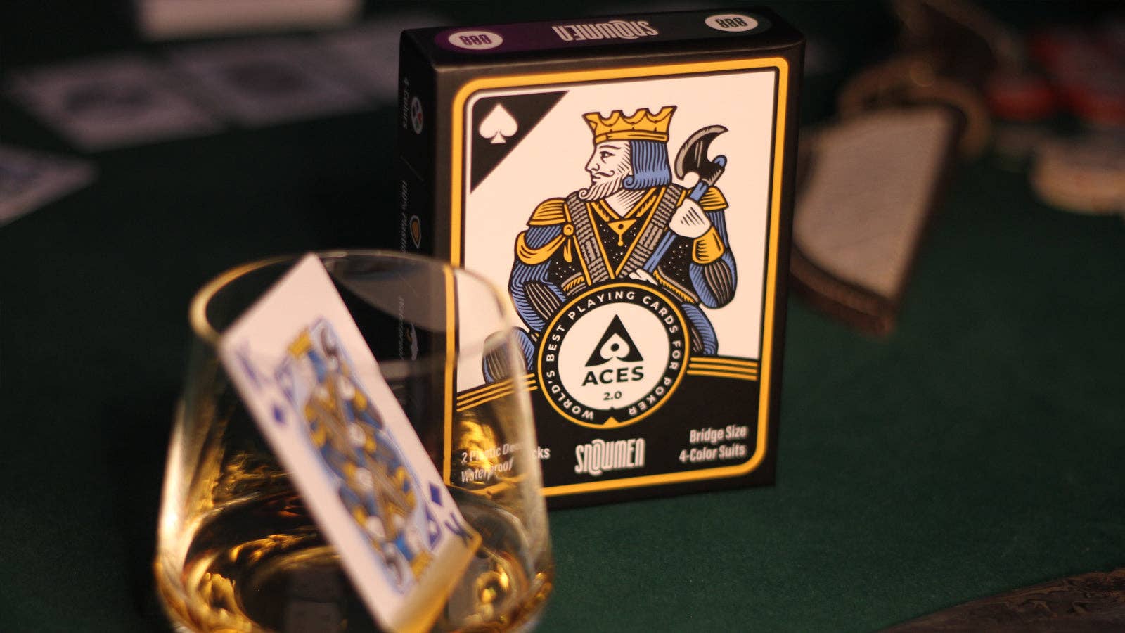 Vanda Aces 2.0 playing cards with a king of spades design on a green surface