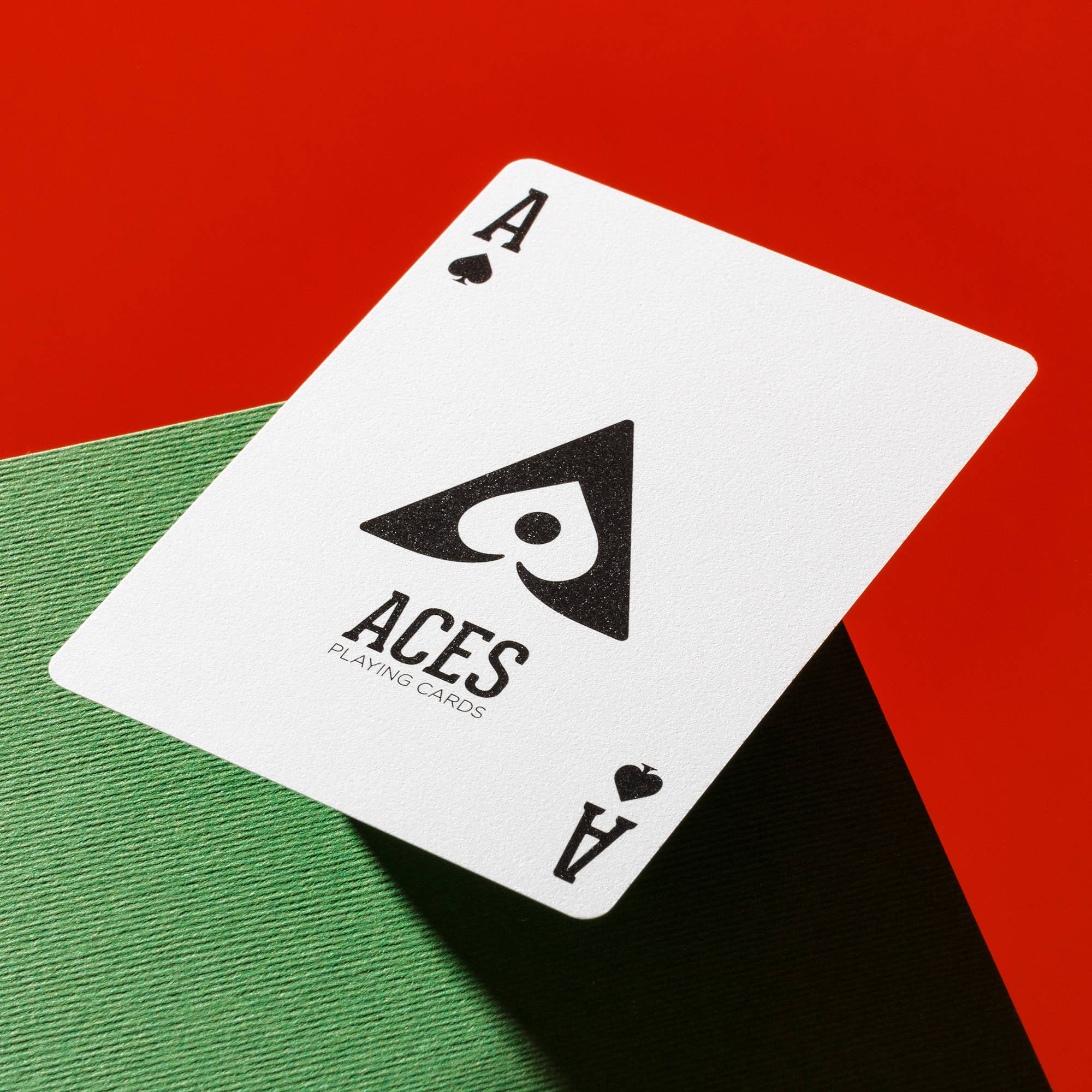 Vanda Aces Red Ace of Spades playing card on a red and green background