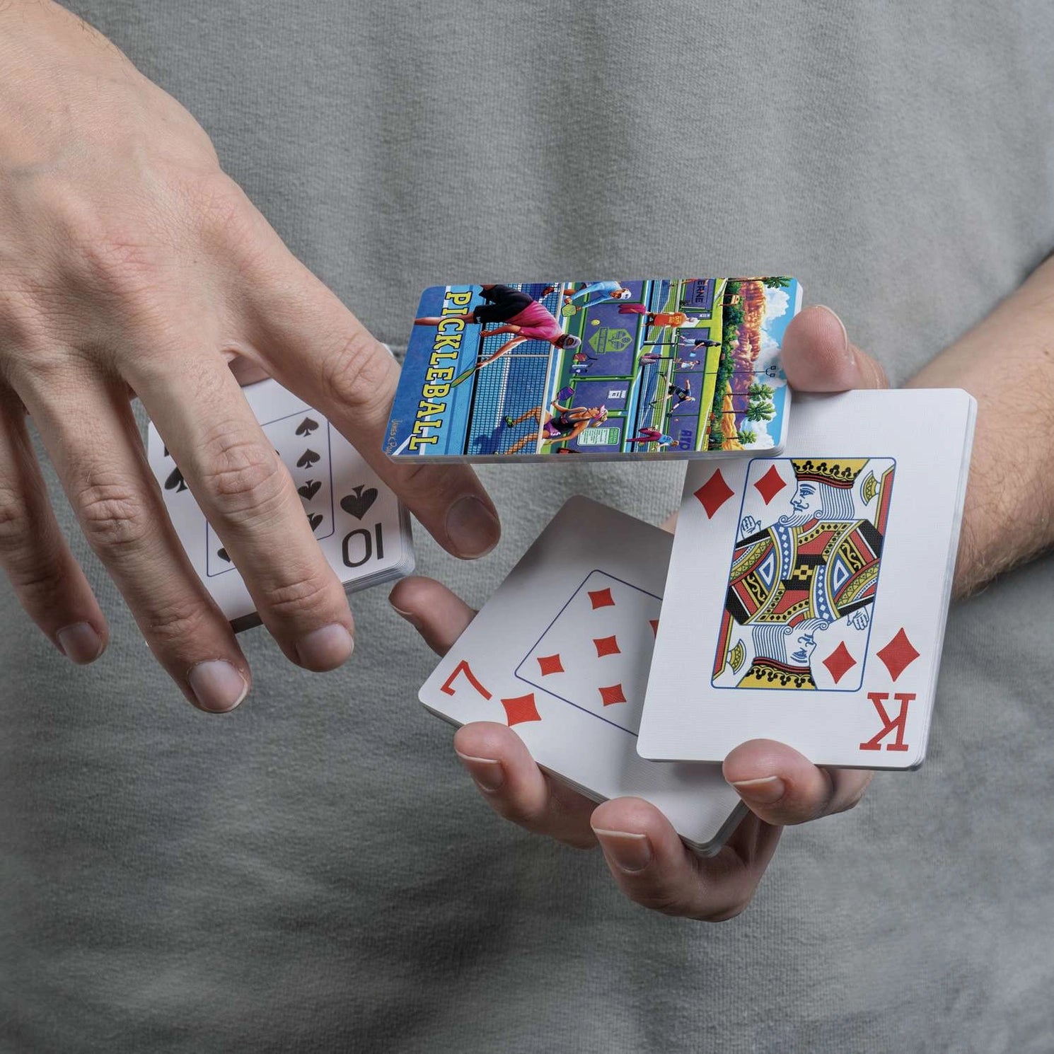 Close-up of Boardwalk Pickleball card back and traditional playing-card faces