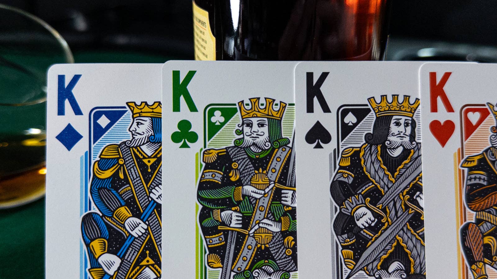 Vanda Aces 2.0 Four kings from different suits on playing cards with a blurred background