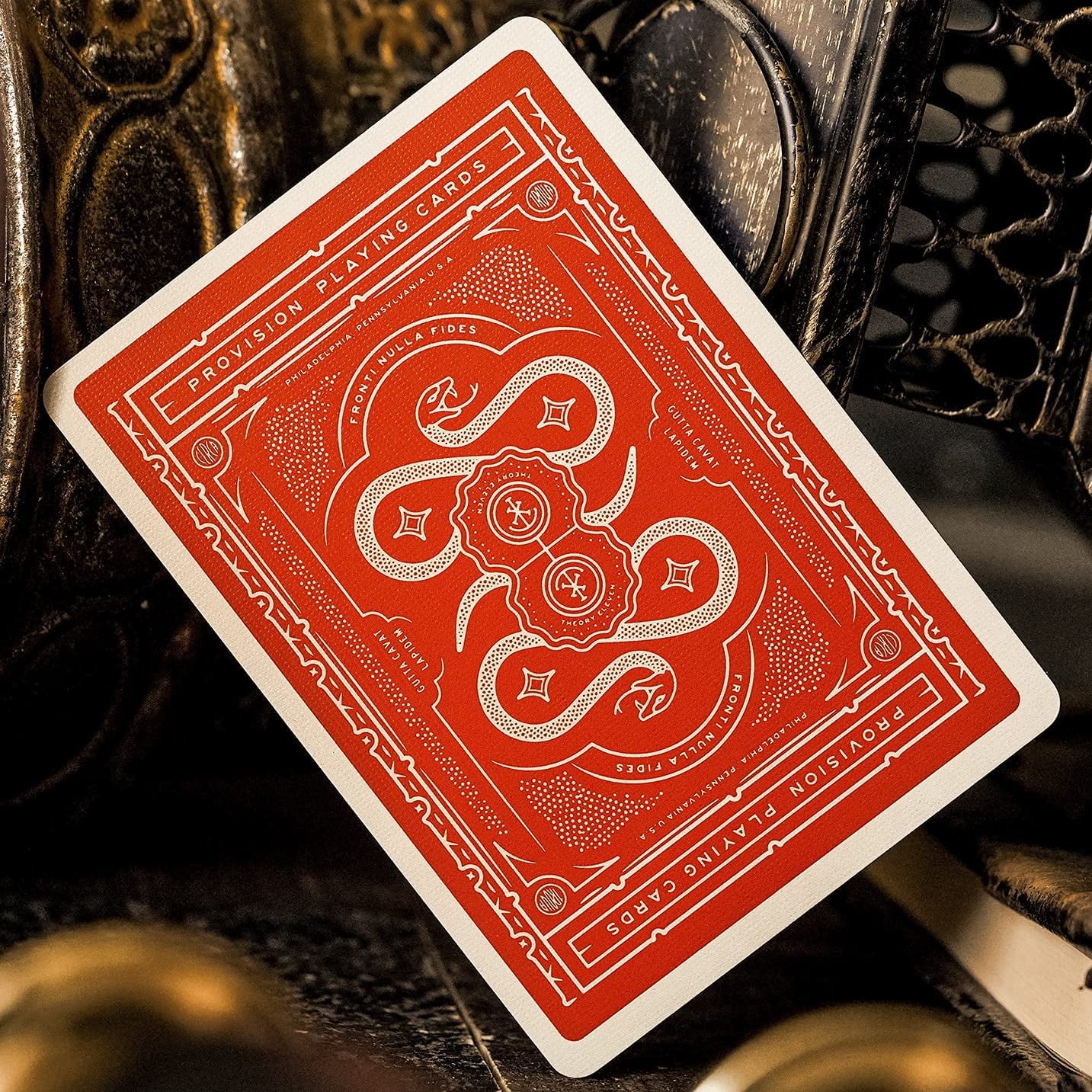 Red playing card with intricate design on a dark background