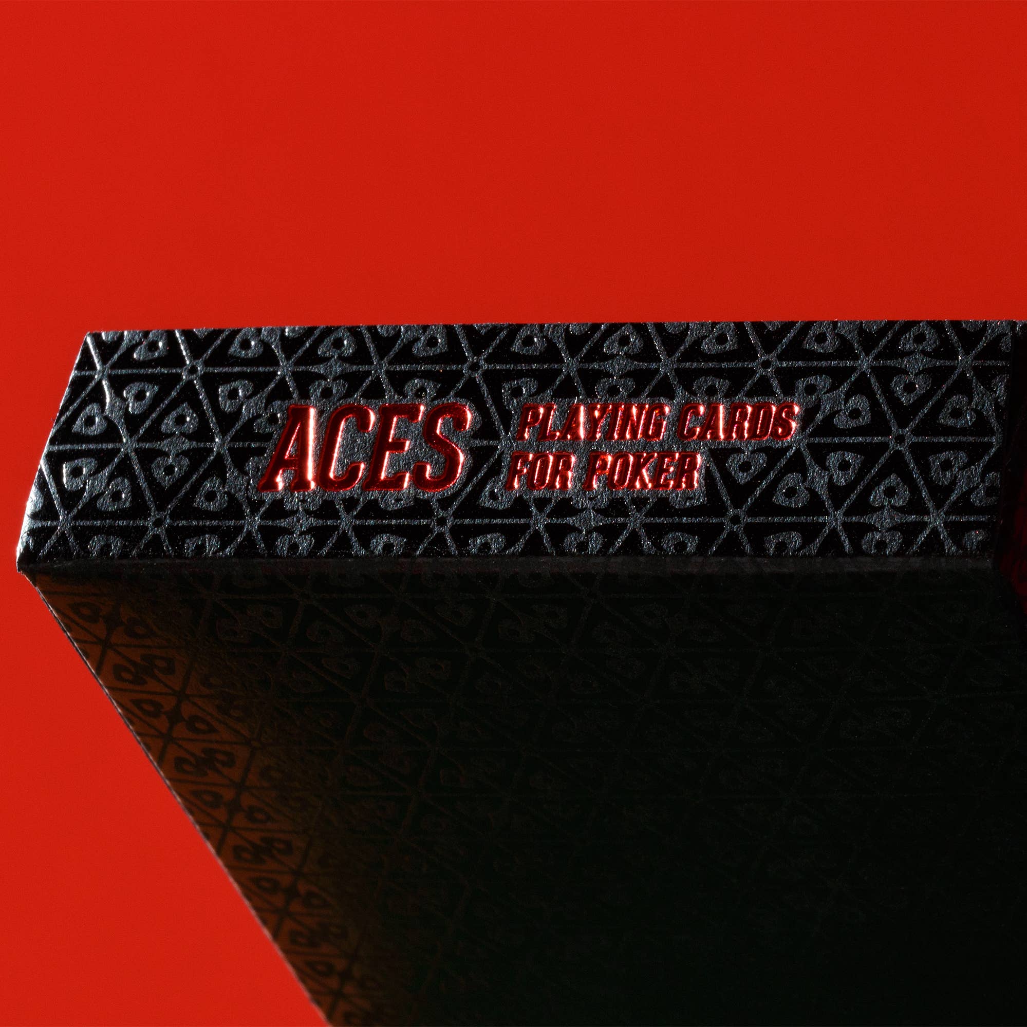 Black playing card box with 'ACES' and 'PLAYING CARDS FOR POKER' text on a red background
