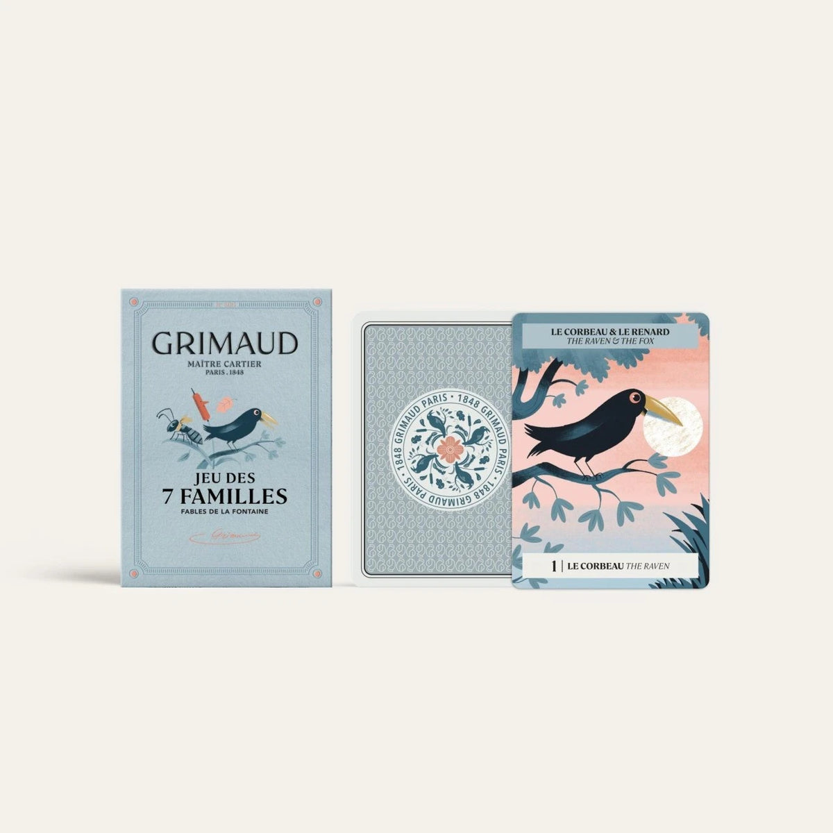 Grimaud N°800 Happy Families box beside a patterned card back and illustrated Raven and Fox game card.