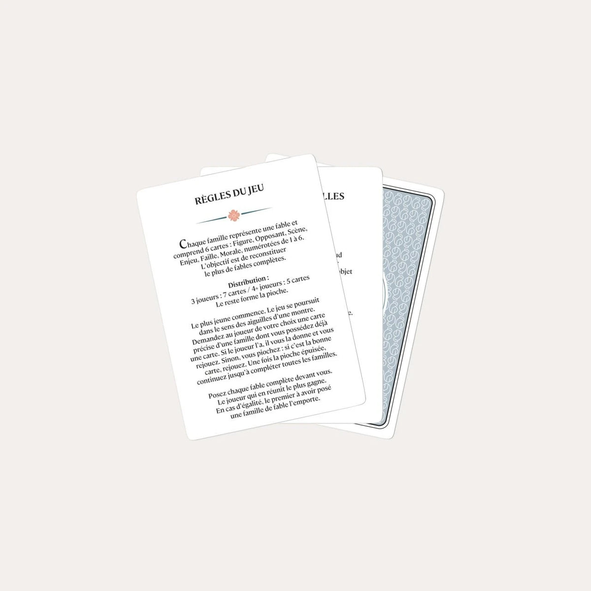 French rules card for Grimaud N°800 Happy Families displayed over a stack of cards.