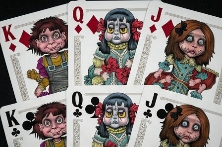 Close-up of Haunted Dolls Playing Cards showing custom Kings, Queens, and Jacks of diamonds and clubs