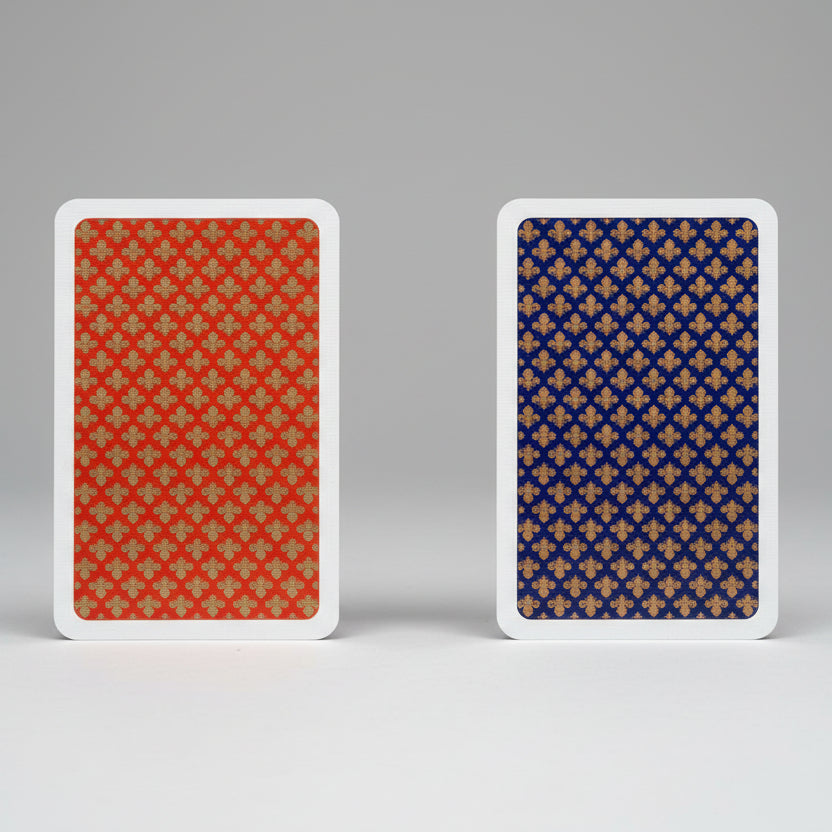 Two playing cards with red and blue backgrounds and gold patterns.