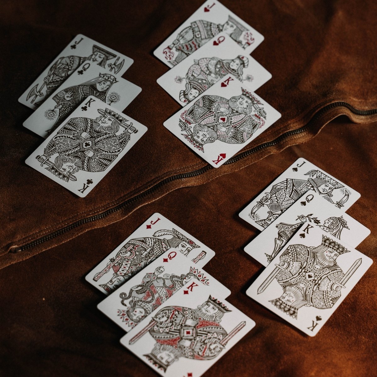 Joker and the Thief White Gold custom court cards arranged on a wooden surface