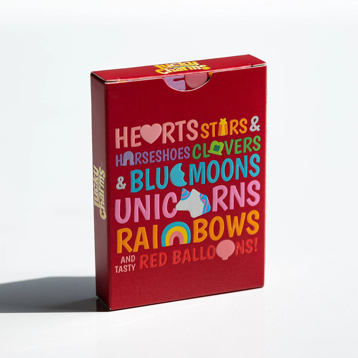 Back of the red Lucky Charms tuck box with colorful lettering and symbols naming the marshmallow charms.