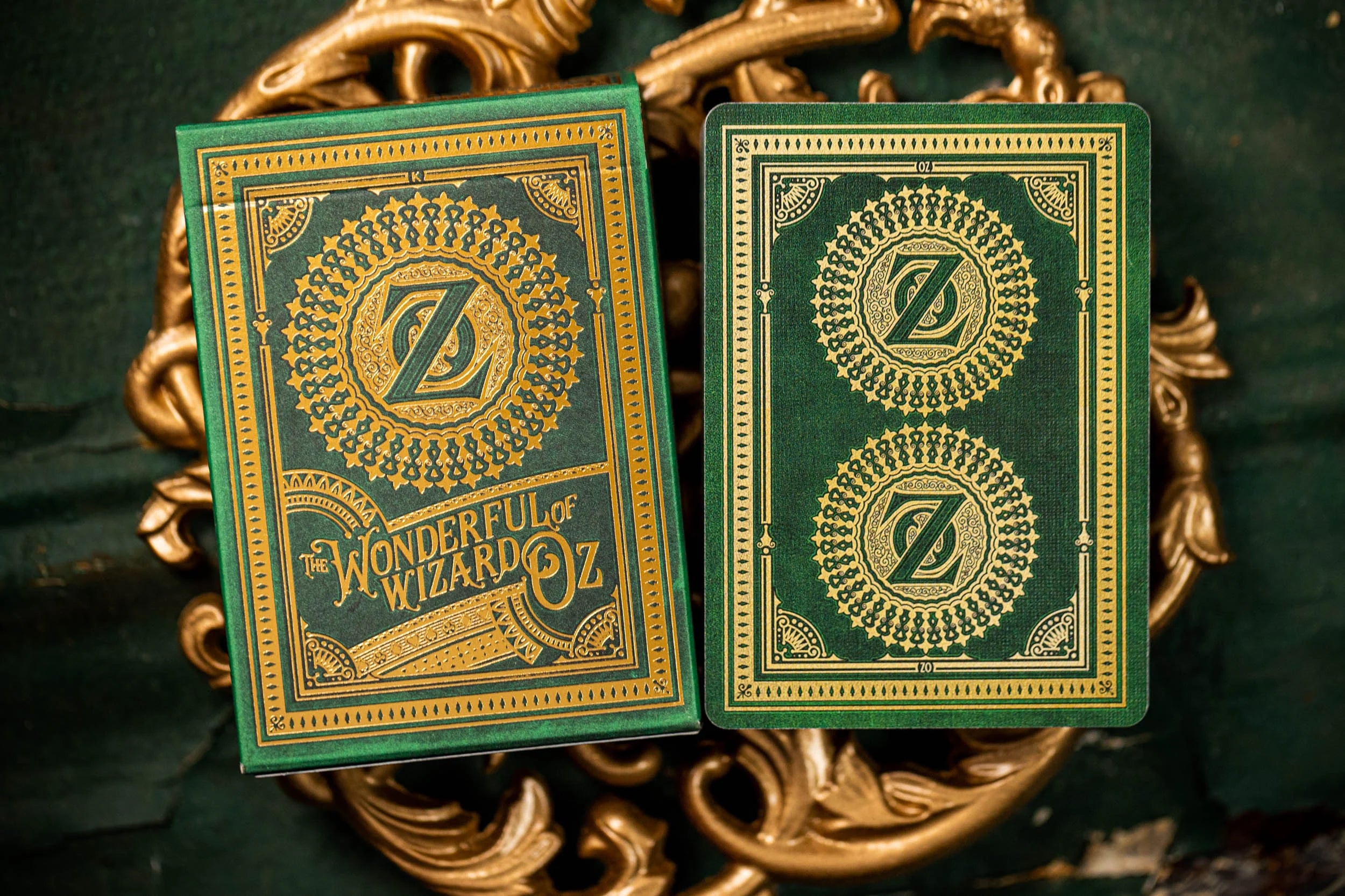 Green and gold playing cards with 'The Wonderful Wizard of Oz' design on a decorative background.