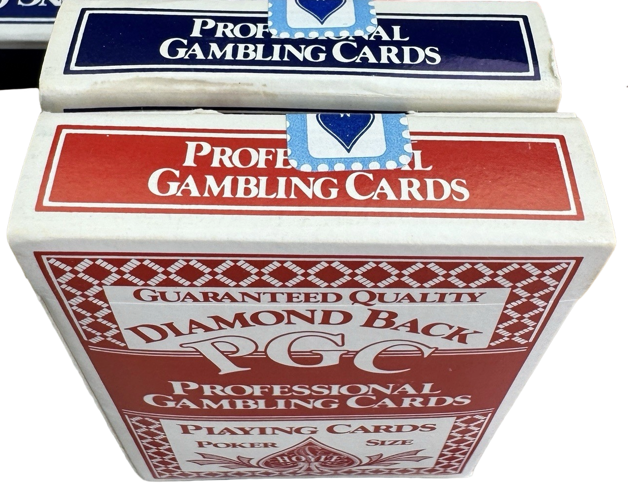 Two boxes of Professional Gambling Cards with red and white design on a white background