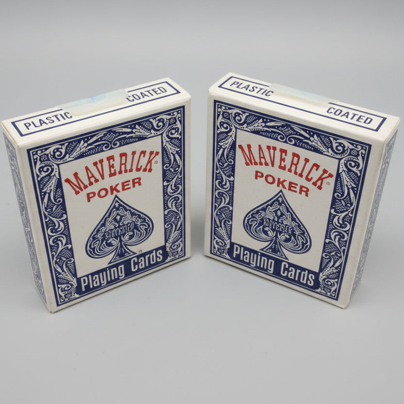 Two packs of Maverick Poker plastic-coated playing cards on a textured gray surface.