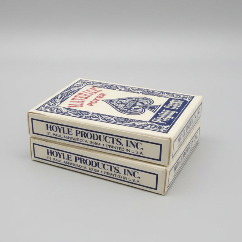 Two boxes of Hoyle Products, Inc. playing cards on a gray surface