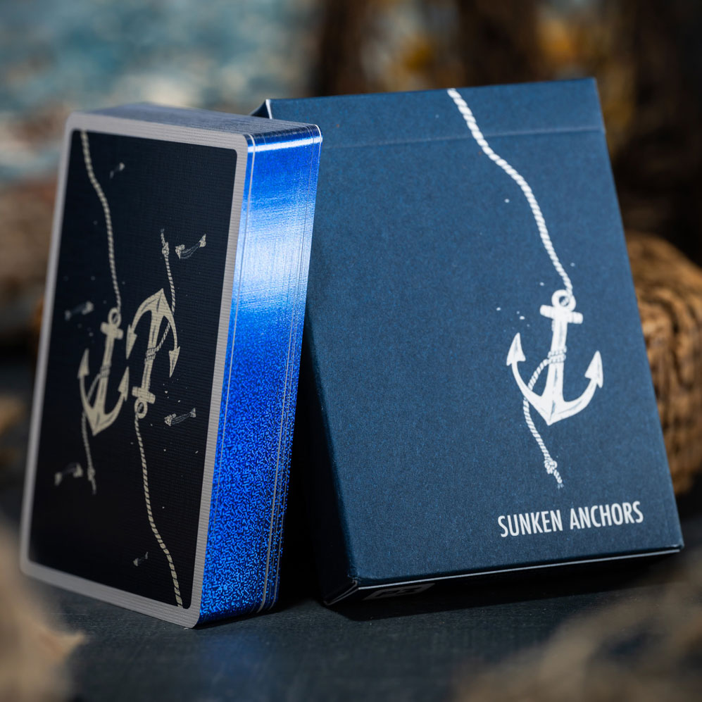 Sunken Anchors Blue Gilded Edition deck showing reflective blue edges beside its navy tuck box.