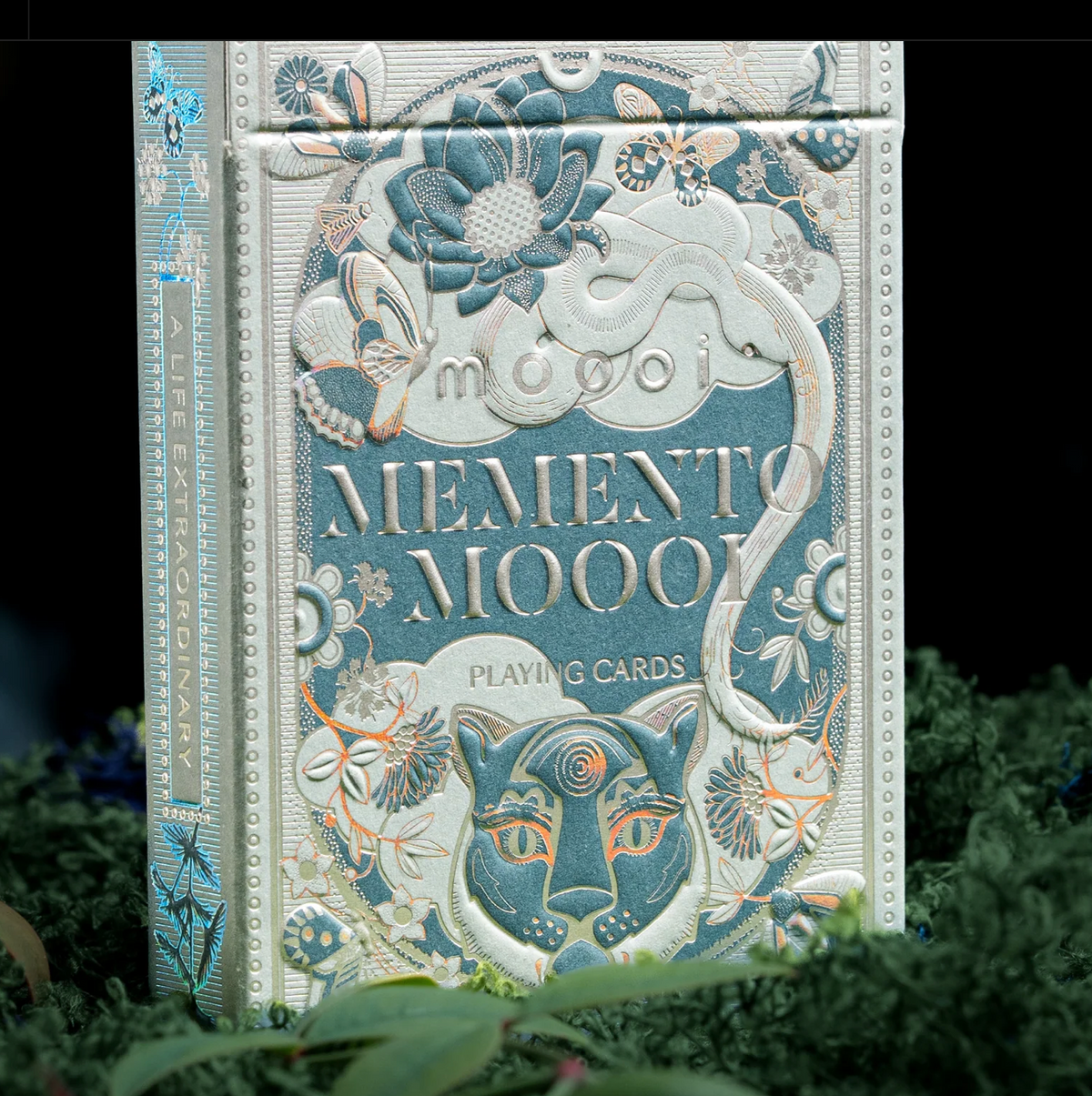 Upright Memento Moooi tuck box showing the illustrated front and left side with A Life Extraordinary lettering.