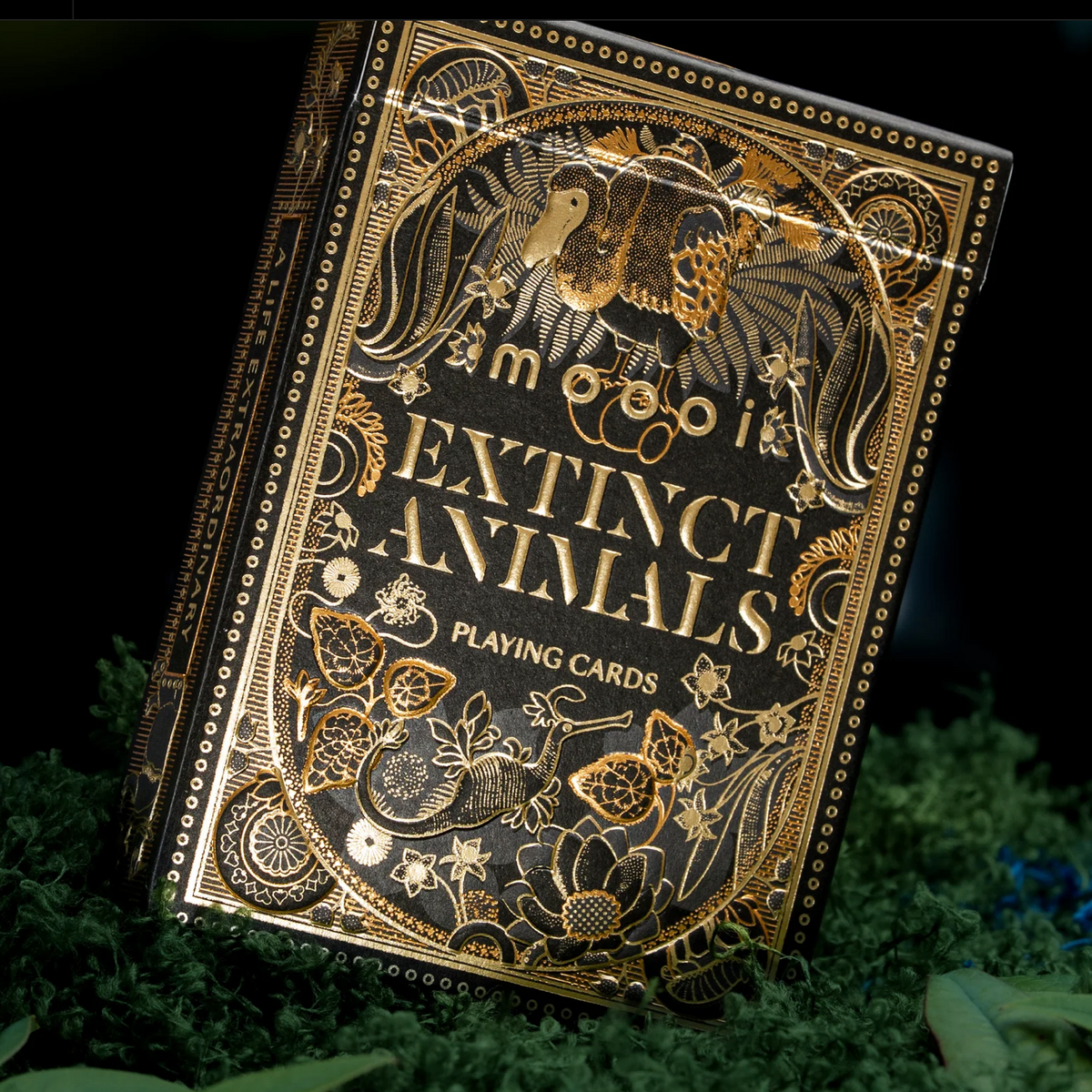 Angled front and left side of the Moooi Extinct Animals tuck box, highlighting gold foil lettering and botanical artwork.