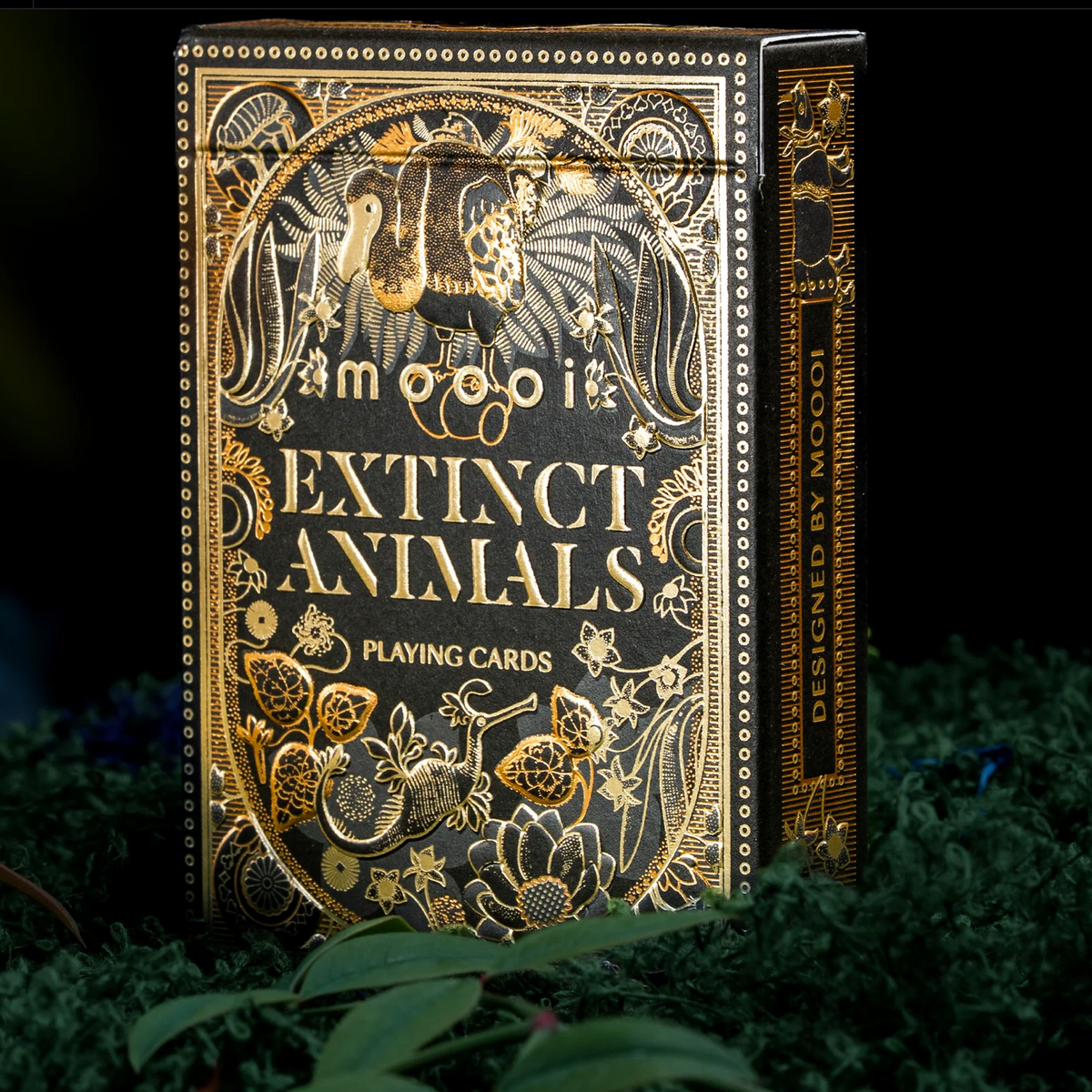 Upright theory11 Moooi Extinct Animals tuck box with gold foil animal artwork and Designed by Moooi lettering on the side.