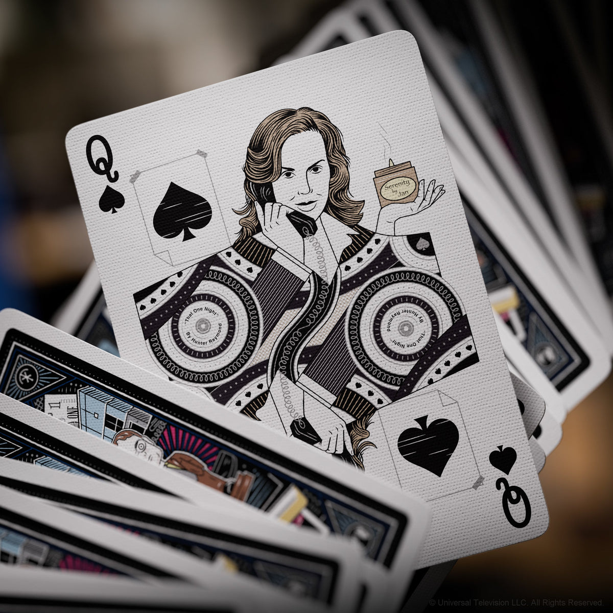 Jan Levinson illustrated on The Office Playing Cards Queen of Spades holding a Serenity by Jan candle