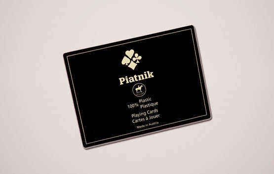 Black Piatnik playing card box on a light gray background