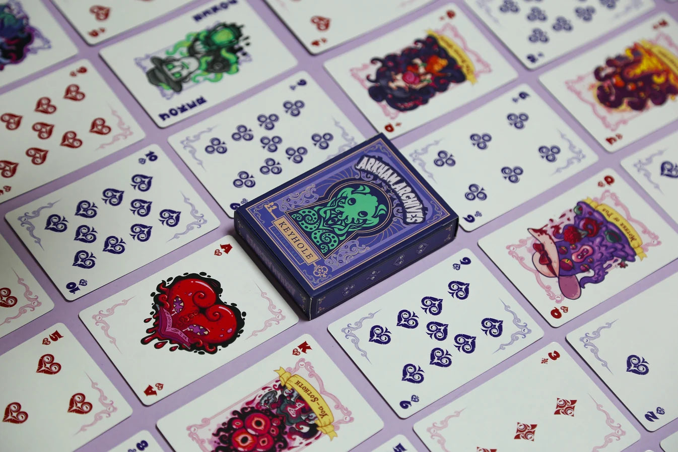 Arkham Archives Cthulhu Mythos deck spread showing custom cards and purple tuck box