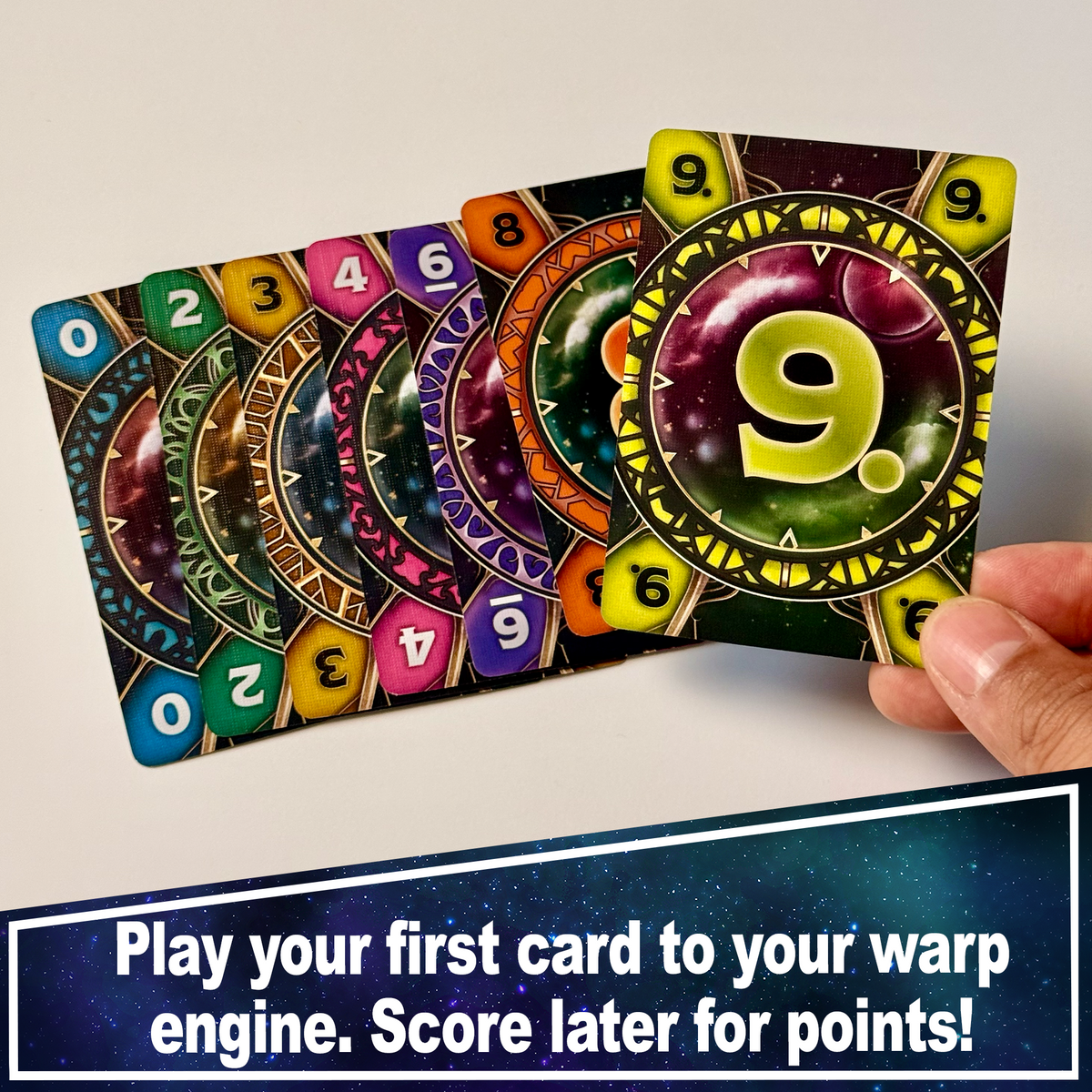 Warp 99 numbered cards fanned in a hand to illustrate building a warp engine.